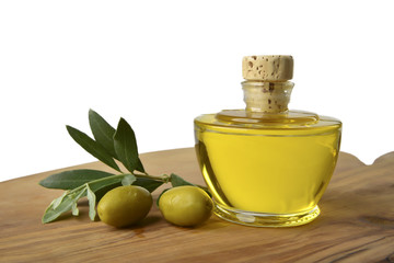 Extra virgin olive oil with olives and leaves close