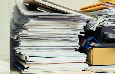 Piles of papers on the Cabinet