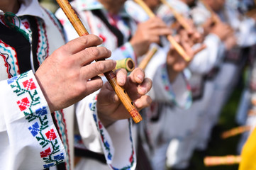 People singing at traditional wooden flutes