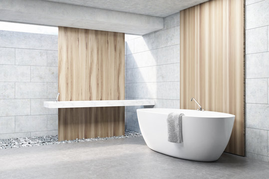 Gray brick bathroom, white tub, side