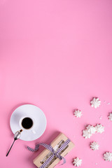 Coffee cup with dessert, meringue cakes on pink background. Top view, copy space. Cafe menu frame.