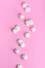Fototapeta na wymiar Meringue dessert over pink background. Bakery product. View from above, flat lay.