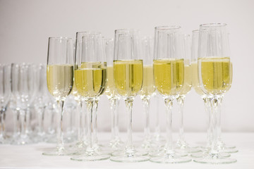 Champagne pour into glasses on the table