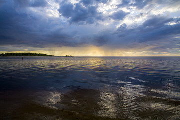 Fototapeta na wymiar Latvia. Sunset on the river. Change in the weather. Elemental binge.