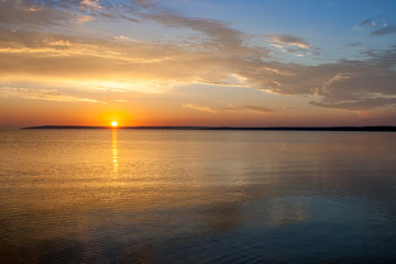 Fototapeta premium Beautiful colorful summer sea sunrise landscape with amazing colorful clouds in a blue sky in Crimea, Azov sea, Ukraine 2013.