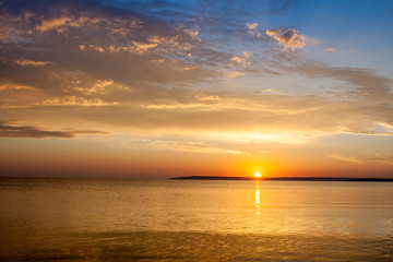 Beautiful colorful summer sea sunrise landscape with amazing colorful clouds in a blue sky in Crimea, Azov sea, Ukraine 2013.