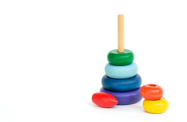 Children's multi-colored wood toy pyramid isolated on white background. Assembled Pyramid