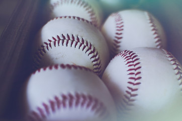 Bunch of white baseballs in a row showing sports equipment for the game.