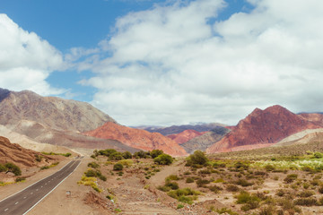 Road to a desert valley with colorful hills in the Andes in Catamarca, Argentina