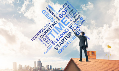 Young businessman standing on house roof and writing leadership 