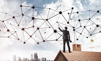 Businessman on house roof presenting networking and connection c