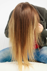 Naklejka premium Girl hiding face behind hairs.