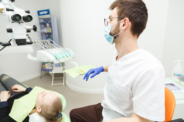 Fototapeta na wymiar Young woman on examination at the dentist