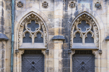 Fototapeta na wymiar Church wall with black doors
