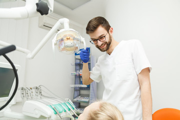 Male dentist and his patient
