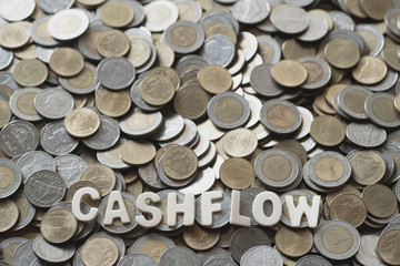 wood text CASHFLOW on coins background , business and finance concept