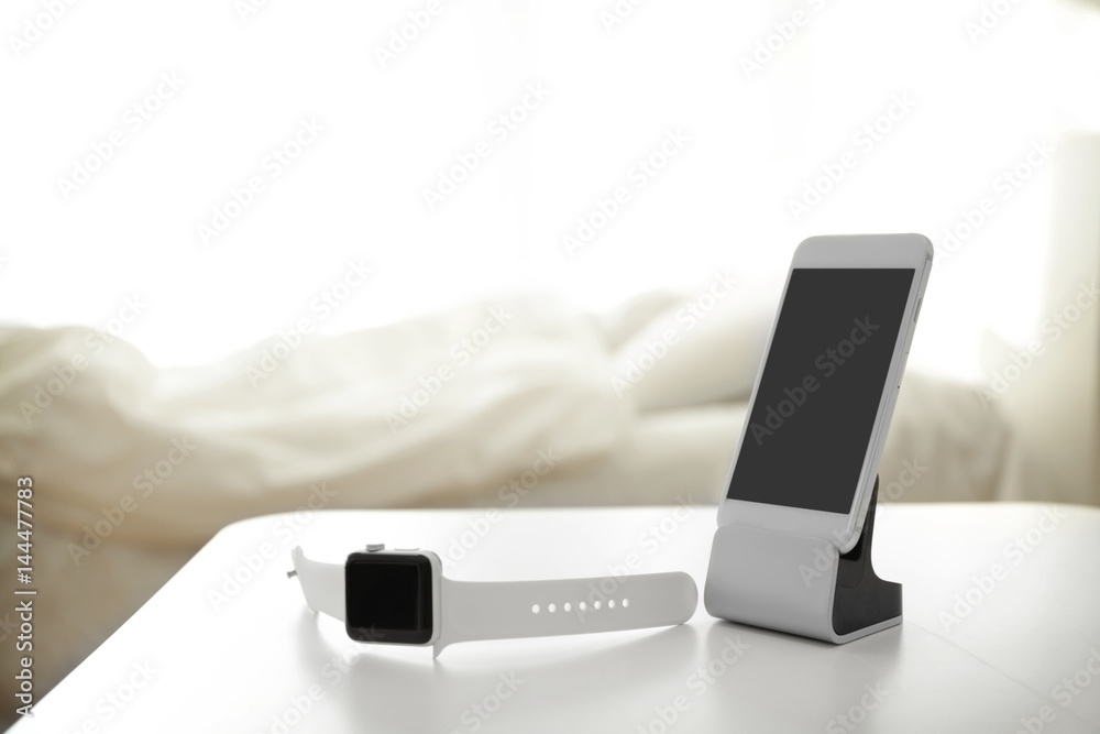 Wall mural Mobile phone and sleep tracker on table in bedroom - Wall murals