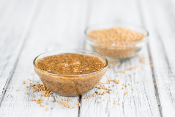 Fresh made Mustard (sweet) on a rustic background
