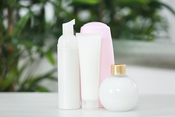 Cosmetic bottles on blurred background