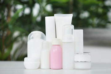 Cosmetic bottles on blurred background