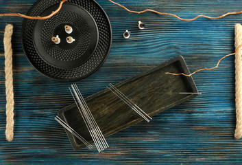 Acupuncture supplies on wooden background - obrazy, fototapety, plakaty