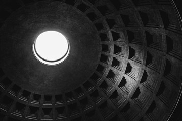 Inside view of the oculus (hole) and dome of the Pantheon in Rome in black and white.