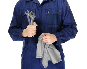 Auto mechanic in uniform on white background, closeup