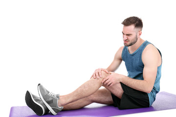 Fototapeta na wymiar Young sporty man suffering from pain in knee on white background