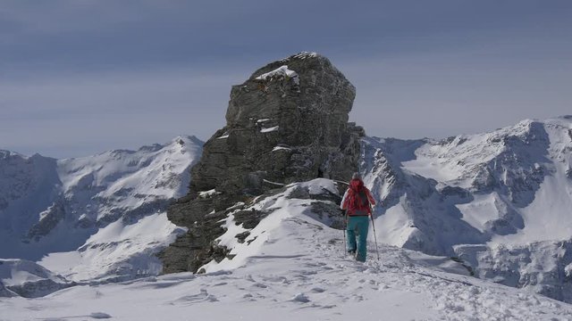Female hiker reaches the top of mountain