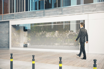 Businessman passing shopfront