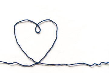Wool yarn in a heart shape. Knitting as a form of manifestation of love and affection.