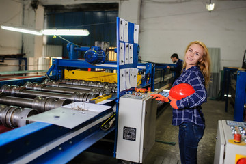 woman in red safety helmet work as industrial worker