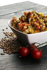 Lentil with carrot and pumpkin ragout in a wooden bowl on a wood
