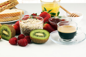 breakfast on table with sandwiches, croissants, coffe and juice