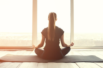 Young beautiful woman practicing yoga and gymnastic. Wellness concept. Classes in single sports.