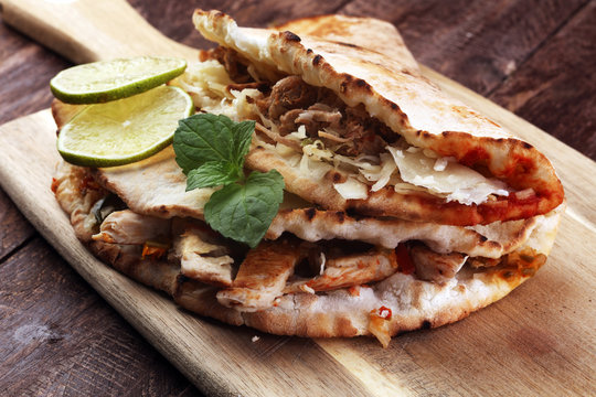 Delicious kebab sandwiches on wooden table