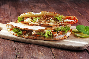 Delicious kebab sandwiches on wooden table