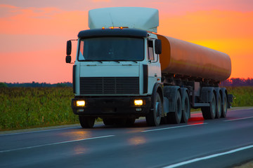 fuel truck goes on highway on sunset