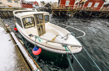 Fototapeta na wymiar Fishing vessel at the pier of traditional fishing settlements of Lofoten islands. Beautiful Norway landscape.