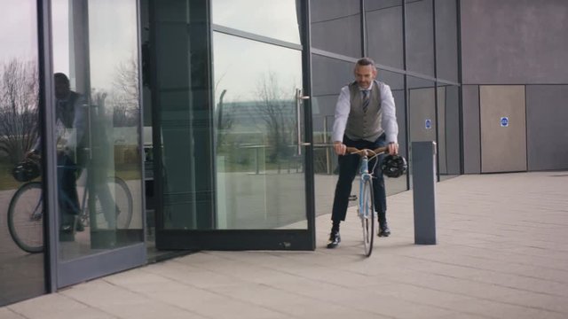  Businessman arriving for work on a bicycle on a sunny day