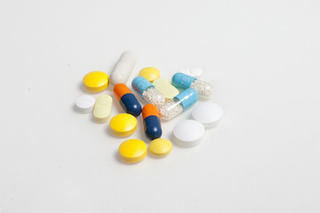 Various Pills and Capsules on White Background