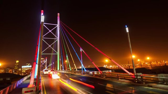 Static timelapse at night shooting down on the Nelson Mandela Bridge in the city centre of Johannesburg, South Africa during peak traffic time