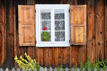 wooden window rural house with shutters and flower