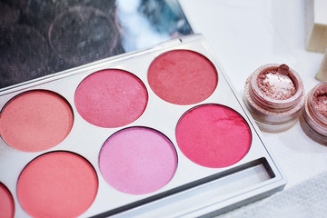 Makeup cosmetics on white background. Shallow focus