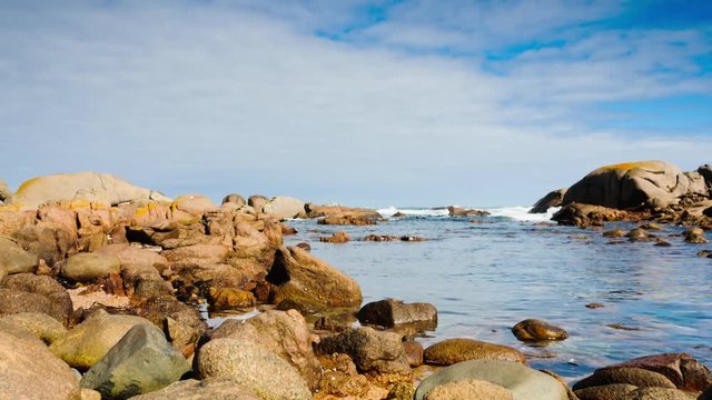 Early morning motion controlled timelapse view on the ocean at Tietiesbaai in the West Coast, South Africa, with rocks in the foreground and small waves crashing.  Linear move on a dolly from left to right at 45 degree angle up available on request.