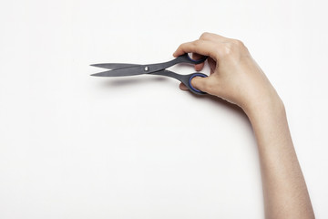 woman(female) hand hold a scissors isolated white.