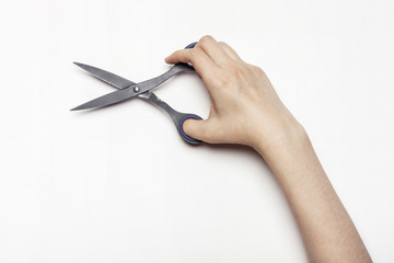 woman(female) hand hold a scissors isolated white.