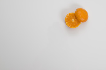 Cut Orange in Corner on White Background