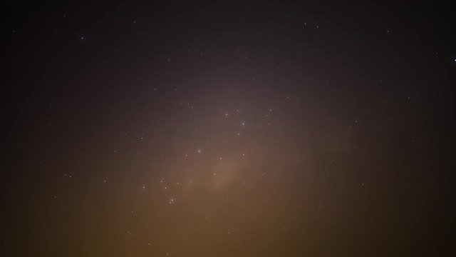 A medium timelapse (generic shot) of the Milky Way and stars as fog rolls (fog on lens) in over the constellations Scorpius, Sagittarius in the Southern Hemisphere while the shot blows out to white at dawn
