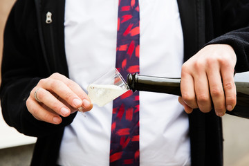 Pouring champagne into a glass on a wedding celebration
